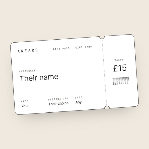 The ANTARO Gift Pass: a white boarding-pass style gift card with a black edge on a cream background, showing Passenger, From, Destination and Gate, and a tear-off stub with the value.